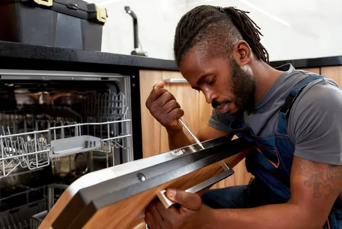 Technician repairing an appliance.
